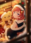 1girl absurdres back_bow blurry blurry_foreground bow bowtie box christmas_tree closed_mouth fireplace fur_trim gift gift_box hat highres indoors looking_at_viewer looking_back love_live! nishikino_maki off_shoulder official_style purple_eyes red_hair santa_hat shiratama_(siratama_ll) smile solo stuffed_animal stuffed_toy teddy_bear twitter_username window 