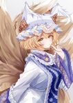  1girl animal_hat blonde_hair blue_tabard blush breasts dress finger_to_mouth fox_tail hat highres kitsune kyuubi lace-trimmed_headwear lace_trim large_breasts looking_at_viewer mob_cap multiple_tails sarasadou_dan slit_pupils solo tabard tail touhou white_dress yakumo_ran yellow_eyes 