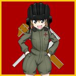  bangs bickle_(bickle1983) blonde_hair blue_eyes border commentary cowboy_shot crossed_arms emblem fang girls_und_panzer green_jumpsuit hands_on_hips helmet katyusha long_sleeves looking_at_viewer military military_uniform open_mouth pravda_(emblem) pravda_military_uniform short_hair short_jumpsuit smile solo standing uniform yellow_border 