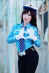  1girl asian brown_hair cosplay d.va_(overwatch) gloves heart officer_d.va overwatch pants photo police_hat police_uniform policewoman rinnie_riot solo 