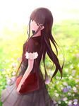  black_hair black_shirt earrings eyebrows_visible_through_hair field floating_hair flower flower_field green_eyes grey_skirt highres jewelry kurosawa_dia long_hair long_skirt looking_at_viewer looking_back love_live! love_live!_sunshine!! mole mole_under_mouth outdoors shirt short_sleeves skirt smile solo standing very_long_hair yuki_(sangeki5806) 