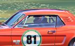  1boy ben_beighton car character_name chromatic_aberration close-up english_commentary english_flag ford ford_mustang from_side helmet highres jacket marta_danecka masters_historic_racing motor_vehicle muscle_car race_vehicle racecar real_life solo white_jacket 
