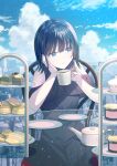  1girl arm_support bare_shoulders black_dress black_hair blue_eyes blue_nails blue_sky cityscape cloud cloudy_sky coffee coffee_mug cup dessert dress food glass_table head_on_hand highres holding holding_cup koh_rd looking_to_the_side mug nail_polish original parted_lips plate sky solo table 