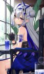  1girl amane_kanata amane_kanata_(another_world) bandaged_arm bandages bare_legs bare_shoulders bendy_straw black_gloves blue_dress blue_hair blurry blurry_background blurry_foreground bokeh breasts colored_inner_hair depth_of_field dress drink drinking_straw earrings from_side gloves grey_hair hair_between_eyes hair_bun hair_ornament halo highres holding hololive indoors jewelry long_hair looking_at_viewer multicolored_hair official_alternate_costume purple_eyes sitting sleeveless sleeveless_dress small_breasts solo star_halo streaked_hair thomas_8000 virtual_youtuber 