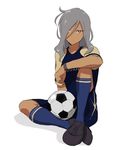  1boy bent_knees closed_mouth dark_skin grey_hair hair_over_one_eye haizaki_ryouhei inazuma_eleven_(series) inazuma_eleven_ares_no_tenbin long_hair looking_at_viewer male_focus multicolored_eyes simple_background sitting soccer_ball soccer_uniform socks solo white_background wristband 