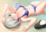  arm_up barefoot beach bikini bird blue_bikini blue_eyes bow_bikini breasts cleavage closed_mouth day failure_penguin folded_leg hamakaze_(kantai_collection) highres kantai_collection leg_up looking_at_viewer lossy-lossless lying medium_breasts miss_cloud navel non-web_source on_back outdoors partially_submerged penguin short_hair silver_hair smile solo sparkle swimsuit takehana_note wet 