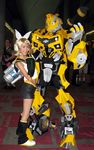  blonde_hair bow bumblebee cosplay couple hetero highres kagamine_rin mecha photo robot shorts transformers vocaloid yellow 