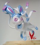  commentary commission creature frown full_body gen_6_pokemon grey_background hair_ribbon neck_ribbon no_humans photo pink_eyes pokemon pokemon_(creature) ribbon sculpture shiny_pokemon signature solo standing standing_on_one_leg sylveon viistar 