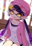  1girl absurdres ao_hito aori_(splatoon) beanie commentary_request earrings eyes_visible_through_hair fang hair_ornament hat highres jacket jewelry looking_at_viewer mole mole_under_eye open_mouth pink_jacket pointy_ears purple_hair sitting smile solo splatoon_(series) splatoon_2 symbol-shaped_pupils tentacle_hair window yellow_eyes 