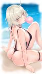  ahoge ass beach black_nails black_swimsuit breasts bubble_blowing chewing_gum commentary_request day fate/grand_order fate_(series) highres jeanne_d'arc_(alter)_(fate) jeanne_d'arc_(fate)_(all) large_breasts looking_at_viewer looking_back mutsu_ane_daisuki nail_polish ocean short_hair sideboob silver_hair sitting slingshot_swimsuit solo swimsuit thigh_strap yellow_eyes 