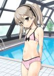  arms_behind_back bikini black_hairband brown_eyes commentary_request flat_chest girls_und_panzer groin hairband indoors jiji light_brown_hair long_hair looking_at_viewer navel pink_bikini plant pool rei_no_pool shimada_arisu side_ponytail smile solo swimsuit 