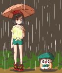  beanie black_hair closed_mouth commentary gen_7_pokemon green_shorts hat holding holding_umbrella leaf_umbrella meka_(77111994) mizuki_(pokemon) orange_umbrella parody pokemon pokemon_(creature) pokemon_(game) pokemon_sm rain red_hat rowlet shirt short_hair short_sleeves shorts standing tied_shirt tonari_no_totoro totoro_bus_stop umbrella 