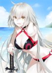  ahoge bare_shoulders beach bikini black_bikini breasts choker cleavage cloud cloudy_sky commentary_request cowboy_shot day eyebrows_visible_through_hair fate/grand_order fate_(series) hair_between_eyes hill jeanne_d'arc_(alter_swimsuit_berserker) jeanne_d'arc_(fate)_(all) katana large_breasts long_hair looking_at_viewer navel o-ring ocean outdoors sky solo swimsuit sword waka_(shark_waka) weapon yellow_eyes 