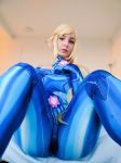  1girl ass bed blonde_hair bodysuit breasts cameltoe cosplay door lamp metroid nintendo photo ponytail room samus_aran samus_aran_(cosplay) shiny shiny_clothes spread_legs tenleid thighs zero_suit 