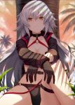  against_tree backlighting bangs bikini black_bikini black_gloves breasts cleavage cloud cloudy_sky commentary eyebrows_visible_through_hair fate/grand_order fate_(series) gloves hair_between_eyes jeanne_d'arc_(alter_swimsuit_berserker) jeanne_d'arc_(fate)_(all) large_breasts long_hair long_sleeves looking_at_viewer o-ring o-ring_bikini orange_sky outdoors palm_tree shadow shrug_(clothing) silver_hair sitting sky soya_(torga) sunset swimsuit thigh_strap tree yellow_eyes 