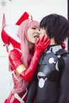  1boy 1girl bangs black_bodysuit black_hair blue_eyes bodysuit cosplay couple darling_in_the_franxx gloves green_eyes hair_ornament hairband hetero hiro_(darling_in_the_franxx) hiro_(darling_in_the_franxx)_(cosplay) horns long_hair oni_horns pilot_suit pink_hair red_bodysuit red_gloves red_horns white_hairband zero_two_(darling_in_the_franxx) zero_two_(darling_in_the_franxx)_(cosplay) 