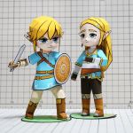  1girl aqua_eyes blonde_hair blue_eyes blue_shirt boots chibi full_body hair_ornament hairclip holding holding_sword holding_weapon link long_hair muumin_(muumin_craft) paper papercraft photo pointy_ears princess_zelda shield shirt short_hair sidelocks standing sword the_legend_of_zelda the_legend_of_zelda:_breath_of_the_wild weapon 