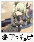  anchovy anzio_military_uniform bangs belt black_belt black_neckwear black_shirt blurry blurry_background closed_mouth commentary_request crossed_arms depth_of_field dress_shirt drill_hair eyebrows_visible_through_hair girls_und_panzer green_hair grey_jacket grey_pants ground_vehicle haniwa_(leaf_garden) highres jacket long_hair long_sleeves looking_at_viewer military military_uniform military_vehicle motor_vehicle necktie pants partial_commentary red_eyes sam_browne_belt shirt smile standing tank twin_drills twintails uniform 