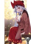  autumn autumn_leaves bangs beanie bench breasts brown_jacket commentary_request day fate/grand_order fate_(series) feet_out_of_frame ginkgo ginkgo_leaf hair_between_eyes hat highres holding holding_leaf horned_headwear horns jacket leaf leaf_print long_hair long_sleeves looking_at_viewer medium_breasts oni oni_horns outdoors pantyhose pom_pom_(clothes) red_eyes red_skirt silver_hair sitting skirt smile solo takubon_(xewh4773) tomoe_gozen_(fate/grand_order) tree 