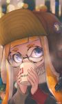  aviator_cap badge bangs blue_eyes blunt_bangs blurry blurry_background cold cup drinking glasses hat hat_pin highres holding holding_cup inkling kashu_(hizake) light_particles looking_at_viewer mug orange_hair round_eyewear signature sipping solo splatoon_(series) steam tentacle_hair upper_body 