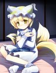  blonde_hair blush commentary covering feet fox_tail hat looking_back multiple_tails niiya short_hair shy socks solo tail touhou yakumo_ran yellow_eyes younger 