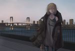  1girl absurdres blonde_hair bridge can cityscape commentary_request denim green_eyes highres holding jacket_on_shoulders jeans looking_at_viewer medium_hair original outdoors oversized_clothes pants shirt_slip solo tabao torn_clothes torn_jeans torn_pants 