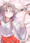  1girl brown_eyes cherry_blossoms closed_mouth commentary_request cowboy_shot flower gedoo_(gedo) hachimaki hair_between_eyes hakama headband high_ponytail highres japanese_clothes kantai_collection light_brown_hair long_hair ponytail red_hakama smile solo zuihou_(kantai_collection) 