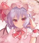 1girl bangs bat_wings beni_kurage blue_hair blush bow bowtie cherry_blossoms commentary_request dress eyebrows_visible_through_hair flower frilled_shirt_collar frills hair_between_eyes hair_flower hair_ornament hand_in_hair hand_up hat hat_ribbon highres looking_at_viewer mob_cap petals pink_background pink_capelet pink_dress pink_flower pink_headwear red_bow red_eyes red_neckwear red_ribbon remilia_scarlet ribbon short_hair solo touhou upper_body wings wrist_cuffs 