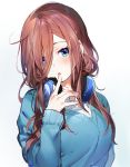  1girl :o blue_eyes blue_sweater blush breasts commentary_request finger_to_mouth go-toubun_no_hanayome hair_over_one_eye head_tilt headphones headphones_around_neck highres large_breasts long_sleeves looking_at_viewer nakano_miku parted_lips red_hair simple_background solo sweater umibouzu_(niito) upper_body white_background 