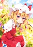  1girl :p arms_behind_back bending_forward blonde_hair blue_sky blurry blush cloud commentary_request cravat crystal day depth_of_field eyebrows_visible_through_hair flandre_scarlet garden hair_between_eyes hat hat_ribbon highres looking_at_viewer miy@ mob_cap outdoors petals puffy_short_sleeves puffy_sleeves red_eyes red_skirt red_vest ribbon shirt short_hair short_sleeves side_ponytail skirt sky solo standing tongue tongue_out touhou vest white_shirt wind wings yellow_neckwear 