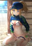  1girl absurdres ahoge artoria_pendragon_(all) bare_legs barefoot baseball_cap beach bikini blonde_hair blue_eyes blue_headwear blue_sky blush breasts cleavage closed_mouth commentary_request day fate/grand_order fate_(series) hair_through_headwear hat highres horizon huge_filesize long_hair long_sleeves looking_at_viewer medium_breasts mysterious_heroine_xx_(foreigner) navel ocean ponytail sand shrug_(clothing) sidelocks sitting sky solo stomach sunlight swimsuit thigh_strap thighs toratora_(nanahaba) untied untied_bikini wariza water white_bikini 