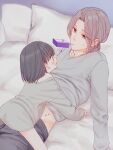  1boy 1girl age_difference black_hair blush couple girl_on_top grey_eyes grey_hair hetero highres juice_box looking_at_another lying mouth_hold on_back open_mouth original pillow short_hair straddling sweatdrop sweater waramugu 