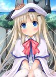  1girl beret between_legs blue_eyes blurry blurry_background cape closed_mouth cloud commentary_request hair_between_eyes hair_ornament hand_between_legs hat highres kudpoid_(71139) light_brown_hair little_busters! looking_at_viewer noumi_kudryavka ocean school_uniform sitting sky smile solo thighhighs 