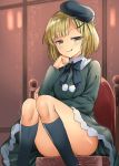  1girl bangs black_legwear blonde_hair blush bow breasts chair commentary_request dress eyebrows_visible_through_hair fate/grand_order fate_(series) green_bow green_headwear green_jacket hat highres indoors jacket kneehighs long_sleeves looking_at_viewer lord_el-melloi_ii_case_files mizuta_kenji reines_el-melloi_archisorte ribbon short_hair sitting small_breasts solo yellow_eyes 