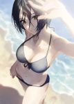  1girl bangs beach bikini black_bikini black_hair blurry_foreground breasts cleavage closed_mouth commentary_request from_above hayami_kanade highres idolmaster idolmaster_cinderella_girls jewelry looking_at_viewer medium_breasts mossi navel necklace ocean parted_bangs short_hair swimsuit waves yellow_eyes 