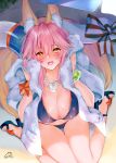  1girl animal_ear_fluff animal_ears bikini blue_bikini blush bow breasts cleavage day fate/grand_order fate_(series) fox_ears fox_tail highres large_breasts long_hair looking_at_viewer navel obiwan open_mouth pink_hair ribbon side-tie_bikini signautre sitting smile solo swimsuit tail tamamo_(fate)_(all) tamamo_no_mae_(fate) tamamo_no_mae_(swimsuit_lancer)_(fate) towel wariza yellow_eyes 