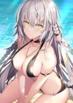  1girl ahoge bangs bare_shoulders beach bikini black_bikini blush braid breasts choker cleavage closed_mouth collarbone fate/grand_order fate_(series) hair_between_eyes heroic_spirit_chaldea_park_outfit jeanne_d&#039;arc_(alter)_(fate) jeanne_d&#039;arc_(fate)_(all) jewelry large_breasts long_hair looking_at_viewer necklace rin_yuu silver_hair sitting solo sunlight swimsuit thighs very_long_hair wariza yellow_eyes 