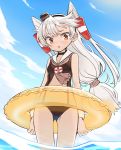  1girl amatsukaze_(kantai_collection) ass_visible_through_thighs blue_sky brown_swimsuit casual_one-piece_swimsuit cloud cowboy_shot day from_below hair_tubes innertube kantai_collection long_hair monaka_ooji one-piece_swimsuit outdoors sailor_collar sailor_swimsuit silver_hair sky soaking_feet solo standing swimsuit two_side_up water white_sailor_collar windsock 