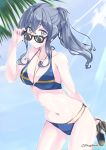  1girl alternate_costume alternate_hairstyle bikini blue_bikini blue_hair blue_sky breasts cloud collarbone cowboy_shot day gotland_(kantai_collection) jewelry kantai_collection leaning_forward light_rays long_hair looking_at_viewer looking_over_eyewear medium_breasts mikage_takashi mole mole_under_eye necklace outdoors palm_tree shoes_removed sky solo standing sunbeam sunglasses sunlight swimsuit tree twitter_username 