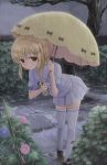  1girl black_footwear blonde_hair bush flower fruits_basket grey_sky hidarikata highres leaning_forward looking_at_viewer morning_glory outdoors rain sailor_collar school_uniform skirt solo souma_kisa standing thighhighs tree umbrella white_legwear yellow_eyes yellow_umbrella 