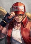  1boy baseball_cap black_gloves blonde_hair blue_eyes clothes_writing collarbone commentary_request copyright_name fatal_fury fingerless_gloves floating_hair gloves hair_between_eyes hand_on_headwear hat highres kuroi_susumu long_hair looking_at_viewer male_focus muscle open_clothes open_vest parted_lips ponytail red_headwear red_vest shadow smile snk solo super_smash_bros. terry_bogard the_king_of_fighters unzipped upper_body vest white_tank_top 