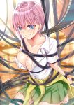  1girl absurdres arms_behind_back bangs bare_shoulders barefoot blue_eyes blush breasts cleavage closed_mouth collarbone commentary_request eyebrows_visible_through_hair go-toubun_no_hanayome green_skirt gu_li hair_between_eyes highres large_breasts looking_at_viewer nakano_ichika pink_hair restrained shirt short_hair skirt smile solo white_shirt 