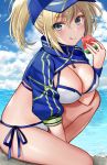  1girl artoria_pendragon_(all) baseball_cap bikini blonde_hair blue_eyes blue_headwear blue_jacket breasts cleavage cloud cloudy_sky commentary_request cropped_jacket day fate/grand_order fate_(series) food fruit hair_between_eyes hair_through_headwear hat highres hijiri_ruka holding holding_food jacket large_breasts mysterious_heroine_xx_(foreigner) ocean ponytail shrug_(clothing) side-tie_bikini sitting_on_ground sky solo swimsuit watermelon white_bikini wristband zipper_pull_tab 