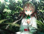  1girl bangs blurry breasts brown_hair covered_mouth dappled_sunlight day depth_of_field dress dsmile green_eyes holding holding_leaf leaf light_rays long_hair long_sleeves looking_at_viewer low_twintails nature original sash smelling solo sunlight twintails upper_body white_dress 