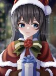  1girl ado_(utaite) alternate_costume averting_eyes black_hair blue_eyes blue_hair blurry blurry_background blush bow bowtie brown_gloves capelet chando_(ado) closed_mouth cloud_nine_inc colored_inner_hair commentary english_commentary flower_brooch fur-trimmed_capelet fur-trimmed_headwear fur_trim gift gloves green_bow green_bowtie hat heart heart_in_eye highres long_hair long_sleeves mole mole_under_eye multicolored_hair nemophila2929 red_capelet red_headwear santa_costume santa_hat signature snowflakes solo symbol_in_eye two-tone_hair utaite 