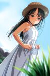  1girl bare_shoulders black_hair blue_sky blurry blurry_background blurry_foreground blush breasts clothes_lift day depth_of_field dress dress_lift dress_straps dutch_angle grey_eyes hat highres long_hair looking_at_viewer looking_to_the_side matsunaga_kouyou nose_blush original outdoors sky small_breasts smile solo strap straw_hat sundress white_dress 