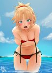  1girl bangs bikini blonde_hair blush braid breasts day fate/grand_order fate_(series) french_braid green_eyes hair_ornament hair_scrunchie highres long_hair looking_at_viewer medium_breasts mordred_(fate)_(all) mordred_(swimsuit_rider)_(fate) navel ocean open_mouth outdoors parted_bangs ponytail red_bikini red_scrunchie scrunchie side-tie_bikini solo swimsuit thanabis untied untied_bikini wading wet 