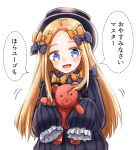  1girl :d abigail_williams_(fate/grand_order) admjgdme bangs black_bow black_dress black_headwear blonde_hair blue_eyes blush bow commentary dotted_line dress fate/grand_order fate_(series) forehead hair_bow hat highres holding holding_stuffed_animal long_hair long_sleeves looking_at_viewer open_mouth orange_bow parted_bangs polka_dot polka_dot_bow simple_background sleeves_past_fingers sleeves_past_wrists smile solo speech_bubble stuffed_animal stuffed_toy teddy_bear translated upper_body very_long_hair white_background 