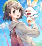  1girl :d ;d backpack bag beret black_hair blue_sky blush brown_eyes day dutch_angle female_protagonist_(pokemon_swsh) from_side gen_8_pokemon green_headwear grey_coat hat holding holding_pokemon hood hood_down hooded_coat lens_flare long_sleeves looking_at_viewer looking_to_the_side one_eye_closed open_mouth orange_eyes outdoors pokemon pokemon_(creature) pokemon_(game) pokemon_swsh scorbunny short_hair sky smile solo upper_body yuduki_(tt-yuduki) 