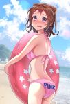  1girl ass bang_dream! beach bikini blue_sky blush breasts brown_hair clothes_writing cloud commentary_request cowboy_shot embarrassed highres innertube looking_at_viewer medium_breasts open_mouth outdoors pink_bikini purple_eyes short_hair sky solo standing swimsuit toyama_kasumi yamamoto_chavez 